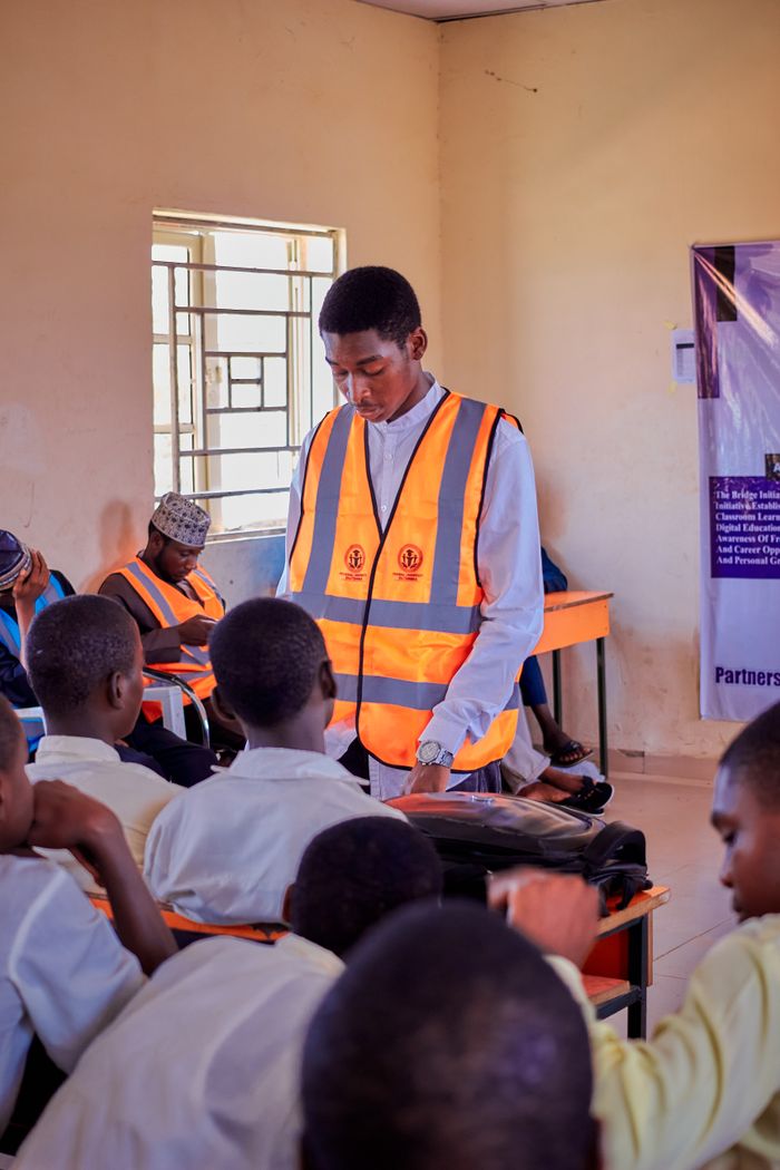 The Art of Drawing Readers In: Your attractive post title goes here Students engage in a guided learning session with a speaker in a Nigerian classroom.